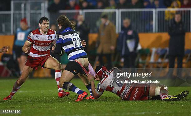 Max Clark of Bath is tackled by Sione Kalamafoni of Gloucester as James Hook closes in during the Anglo Welsh Cup match between Bath Rugby and...