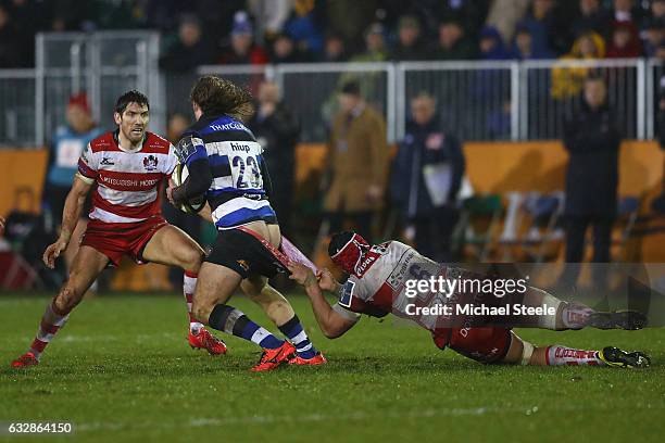 Max Clark of Bath is tackled by Sione Kalamafoni of Gloucester as James Hook closes in during the Anglo Welsh Cup match between Bath Rugby and...