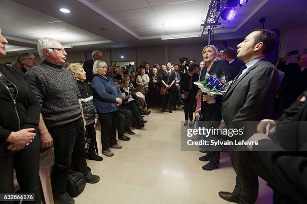 French far-right party National Front leader Marine Le Pen attends sings french national hymn "La Marseillaise" after a private meeting with FN...