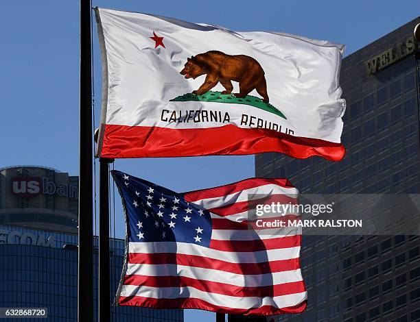 The California State flag flies beside a sign for its sister city Split outside City Hall, in Los Angeles, California on January 27, 2017. A campaign...