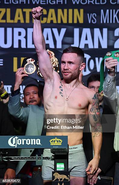 Featherweight champion Carl Frampton poses on the scale during his official weigh-in at MGM Grand Garden Arena on January 27, 2017 in Las Vegas,...