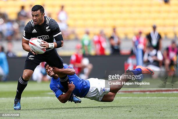 Sherwin Stowers of New Zealand is tackled by Samoa Toloa of Samoa in the pool match between New Zealand and Samoa during the 2017 Wellington Sevens...