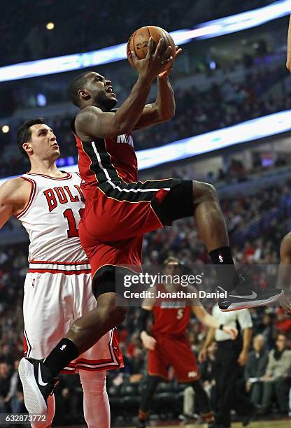Dion Waiters of the Miami Heat goes up for a shot past Paul Zipser of the Chicago Bulls at the United Center on January 27, 2017 in Chicago,...