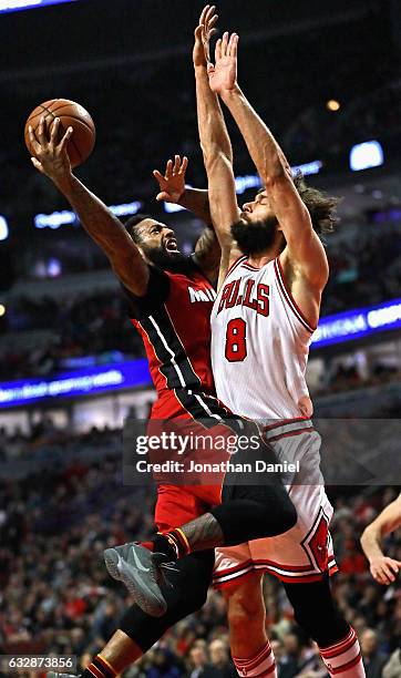 James Johnson of the Miami Heat puts up a shot against Robin Lopez of the Chicago Bulls at the United Center on January 27, 2017 in Chicago,...