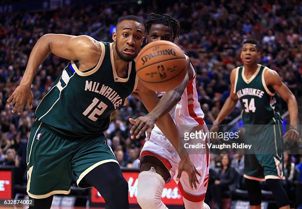 DeMarre Carroll of the Toronto Raptors and Jabari Parker of the Milwaukee Bucks chase a loose ball during the second half of an NBA game at Air...