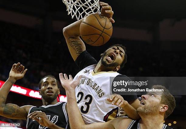 Anthony Davis of the New Orleans Pelicans rebounds the ball over Kawhi Leonard of the San Antonio Spurs and David Lee during the second half of a...