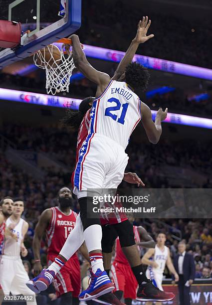 Joel Embiid of the Philadelphia 76ers dunks the ball against Nene Hilario of the Houston Rockets in the first quarter at the Wells Fargo Center on...