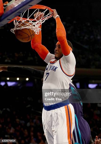 Carmelo Anthony of the New York Knicks dunks the ball as Roy Hibbert of the Charlotte Hornets defends at Madison Square Garden on January 27, 2017 in...