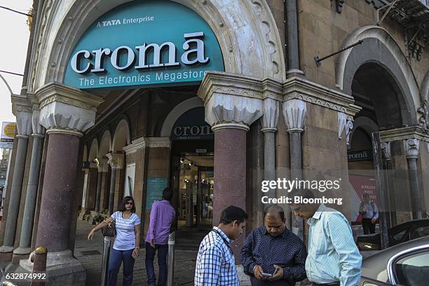 Pedestrians stand in front of a Croma electronics megastore operated by Infiniti Retail Ltd., a unit of Tata Group, in Mumbai, India, on Friday, Jan....