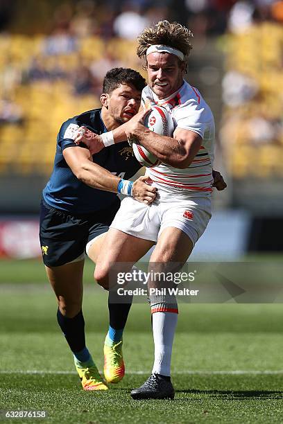 Tom Mitchell of England is tackled in the match between England and Argentina during the 2017 Wellington Sevens at Westpac Stadium on January 28,...