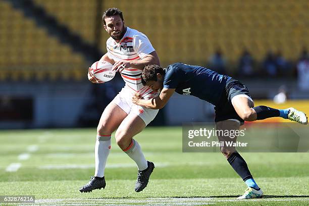 Charlie Hayter of England is tackled in the match between England and Argentina during the 2017 Wellington Sevens at Westpac Stadium on January 28,...