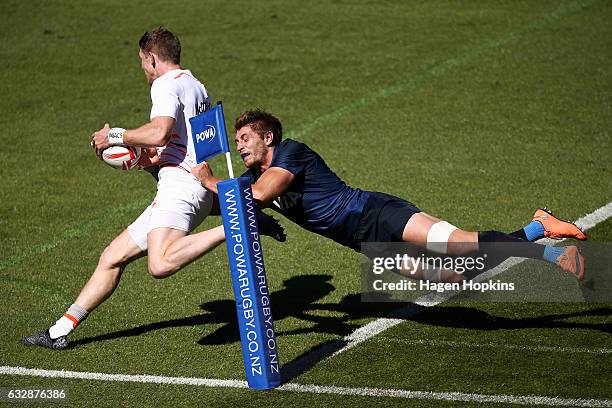 Ruaridh McConnochie of England has the ball dislodged by the tackle of Matias Osadczuk of Argentina while attempting to score a try in the pool match...