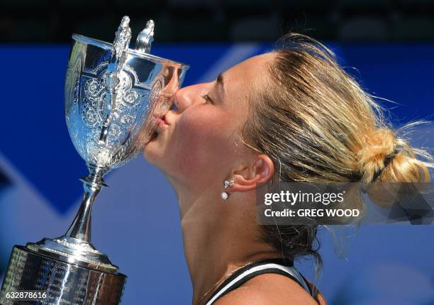 Ukraine's Marta Kostyuk kisses the championship trophy after defeating Rebeka Masarova of Switzerland in the junior girl's singles final on day 13 of...