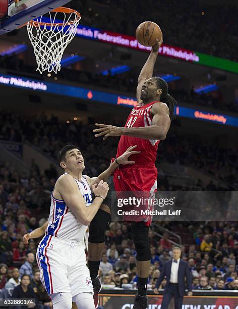 Nene Hilario of the Houston Rockets dunks the ball against Ersan Ilyasova of the Philadelphia 76ers in the third quarter at the Wells Fargo Center on...
