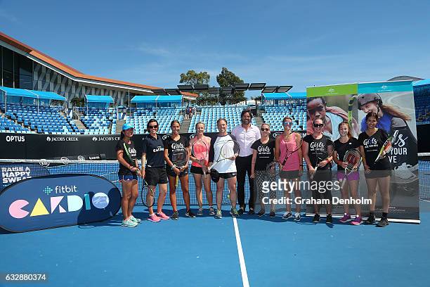 Federal Minister for Health and Minister for Sport Greg Hunt poses with Pat Rafter and a group of girls who took part in a cardio tennis session...