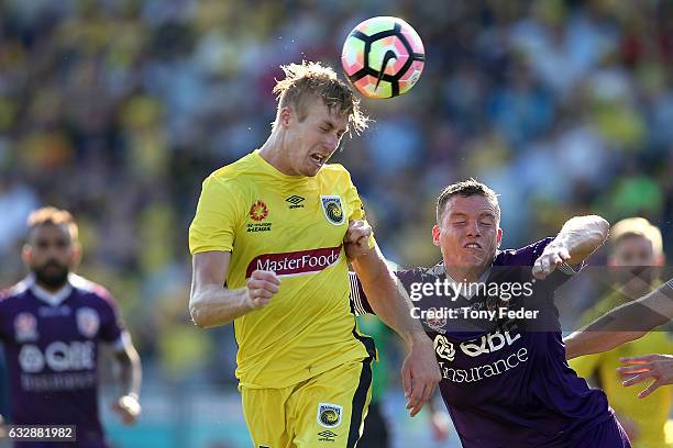 Josh Bingham of the Mariners contests a header with Shane Lowry of the Glory during the round 17 A-League match between the Central Coast Mariners...