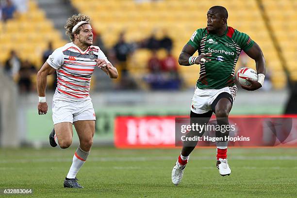 Willy Ambaka of Kenya breaks away from Tom Mitchell of England in the pool match between England and Kenya during the 2017 Wellington Sevens at...