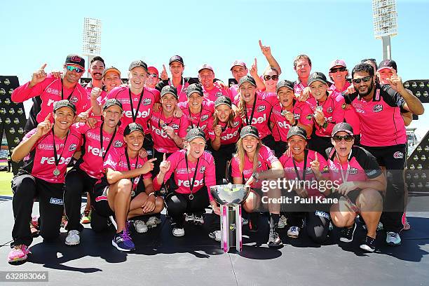 The Sixers celebrate with the trophy after winning the Women's Big Bash League match between the Perth Scorchers and the Sydney Sixers at WACA on...