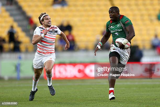 Willy Ambaka of Kenya breaks away from Tom Mitchell of England in the pool match between England and Kenya during the 2017 Wellington Sevens at...