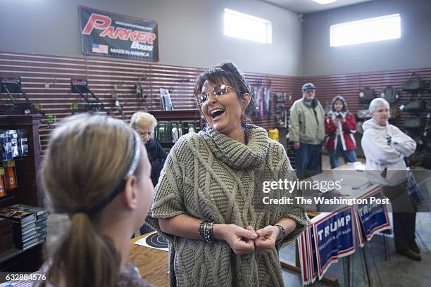 Former Alaska Gov. Sarah Palin greets people as she campaigns for republican presidential candidate Donald Trump at Zingers & Flingers indoor...