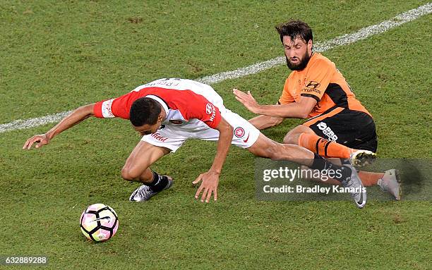 Kearyn Baccus of the Wanderers is tackled by Thomas Broich of the Roar during the round 17 A-League match between the Brisbane Roar and the Western...