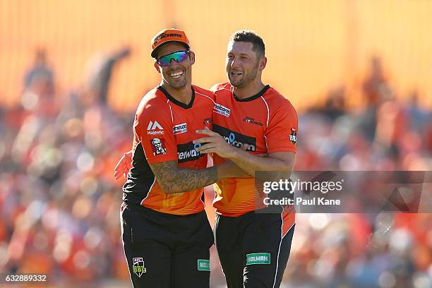 Mitchell Johnson and Tim Bresnan of the Scorchers celebrate the wicket of Johan Botha of the Sixers during the Big Bash League match between the...