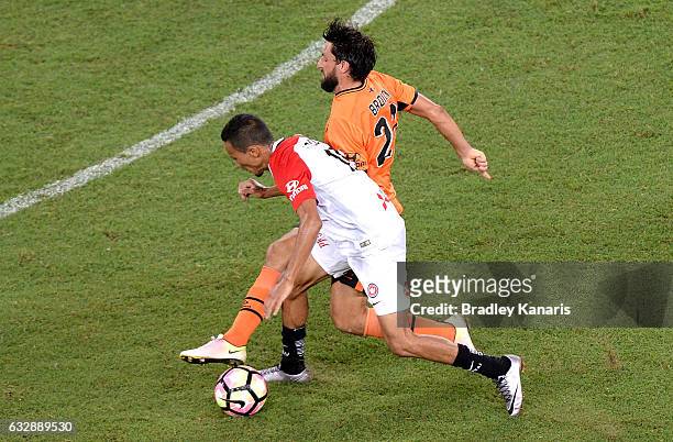 Thomas Broich of the Roar and Kearyn Baccus of the Wanderers challenge for the ball during the round 17 A-League match between the Brisbane Roar and...