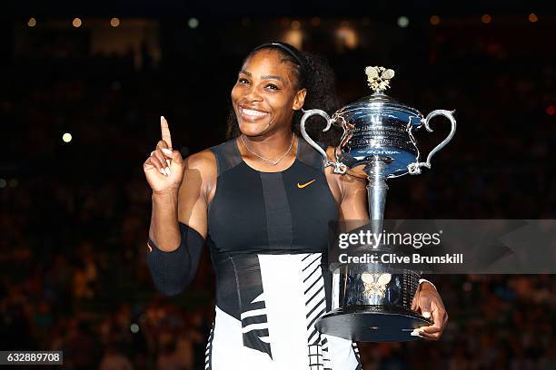 Serena Williams poses with the Daphne Akhurst Trophy after winning the Women's Singles Final against Venus Williams of the United States on day 13 of...