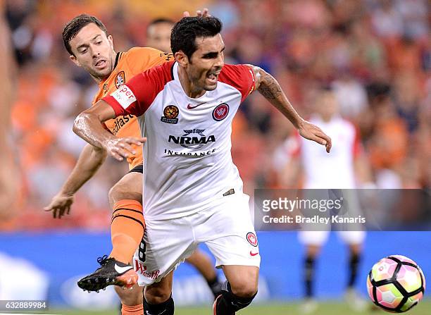 Dimas Delgado of the Wanderers is pressured by the defence of Tommy Oar of the Roar during the round 17 A-League match between the Brisbane Roar and...
