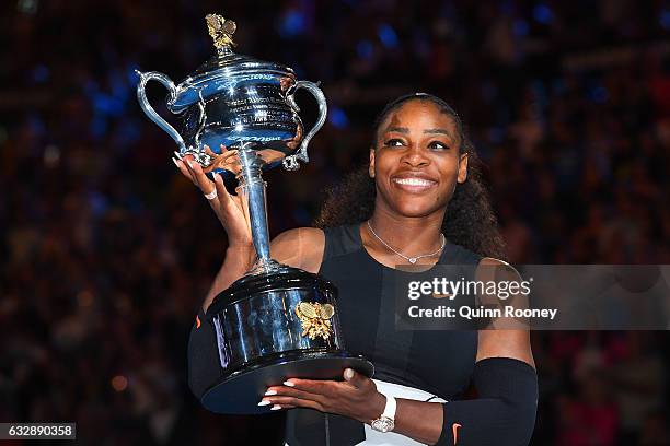 Serena Williams of the United States poses with the Daphne Akhurst Trophy after winning the Women's Singles Final against Venus Williams of the...