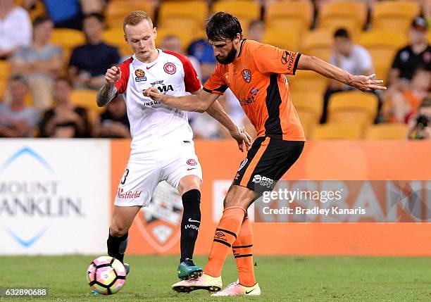 Thomas Broich of the Roar takes on the defence of Jack Clisby of the Wanderers during the round 17 A-League match between the Brisbane Roar and the...