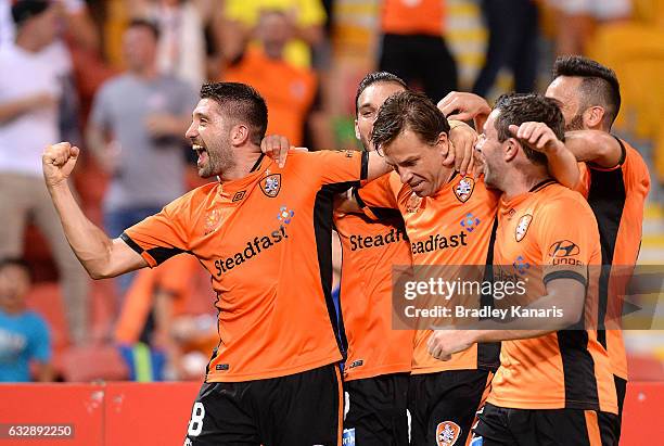 Brett Holman of the Roar is congratulated by team mates after scoring a goal during the round 17 A-League match between the Brisbane Roar and the...