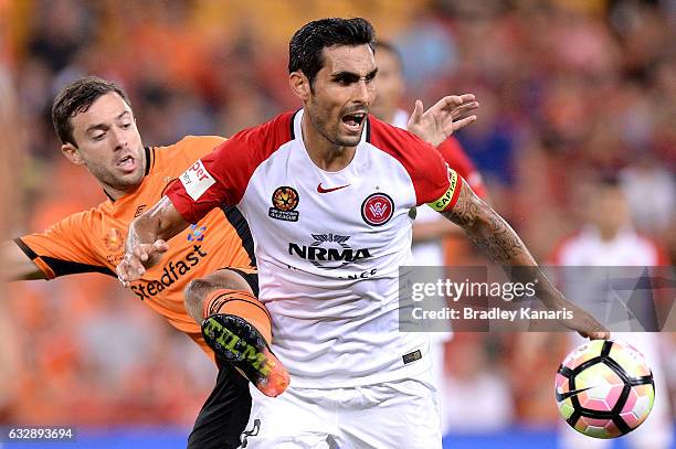 Dimas Delgado of the Wanderers is challenged by the defence of Tommy Oar of the Roar during the round 17 A-League match between the Brisbane Roar and...