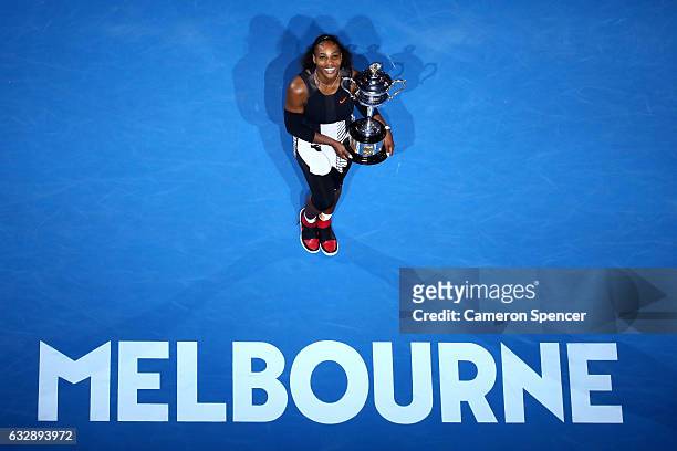 Serena Williams of the United States poses with the Daphne Akhurst Trophy after winning the Women's Singles Final against Venus Williams of the...