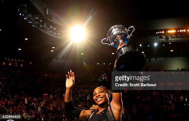 Serena Williams waves to the crowd as she leaves the court with the Daphne Akhurst Trophy after winning the Women's Singles Final against Venus...