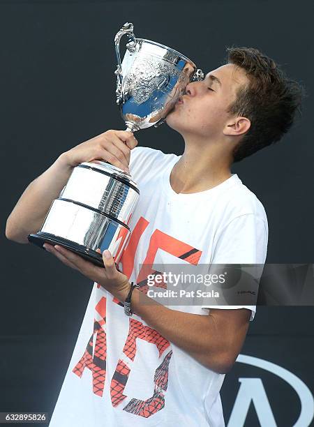 Zsombor Piros of Hungary kisses the championship trophy after winning the Junior Boys Singles Final against Yshai Oliel of Israel during the...