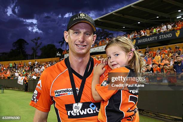 Adam Voges of the Scorchers carries his daughter around the ground for a lap of honour after winning the Big Bash League match between the Perth...