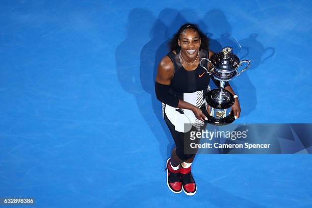 Serena Williams of the United States poses with the Daphne Akhurst Trophy after winning the Women's Singles Final against Venus Williams of the...