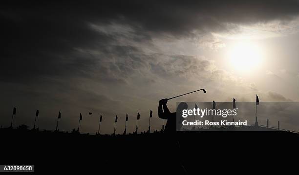 Andy Sullivan of England plays his third shot on the par five 18th hole during the third round of the Commercial Bank Qatar Masters at Doha Golf Club...