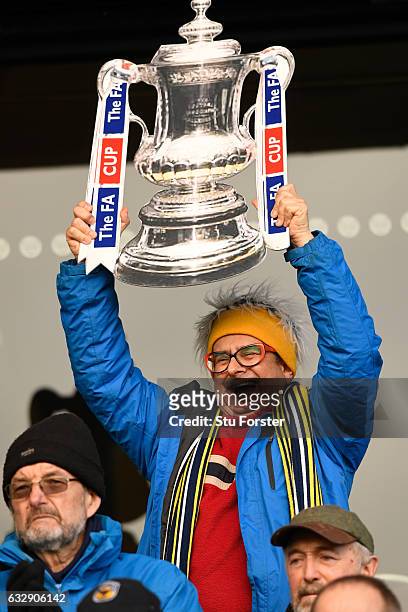 Timmy Mallett, holds up an FA Cup during the Emirates FA Cup Fourth Round match between Oxford United and Newcastle United at Kassam Stadium on...