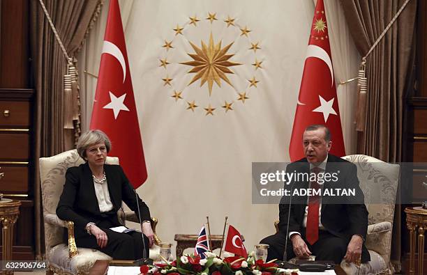 Turkey's President Recep Tayyip Erdogan and British Prime Minister Theresa May speak after their meeting at the presidential complex in Ankara on...