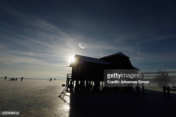 Visitors enjoy the frozen Lake Ammersee on January 28, 2017 in Stegen am Ammersee, Germany. After an unusual cold winter period currently most of the...