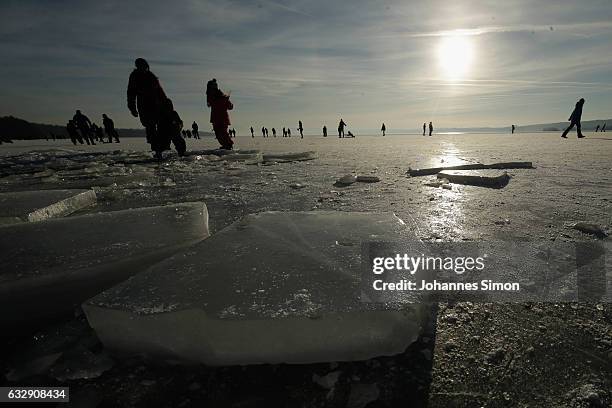 Visitors enjoy skating and walking on Lake Ammersee on January 28, 2017 in Stegen am Ammersee, Germany. After an unusual cold winter period currently...