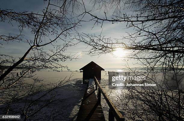 Visitors enjoy the frozen Lake Ammersee on January 28, 2017 in Stegen am Ammersee, Germany. After an unusual cold winter period currently most of the...