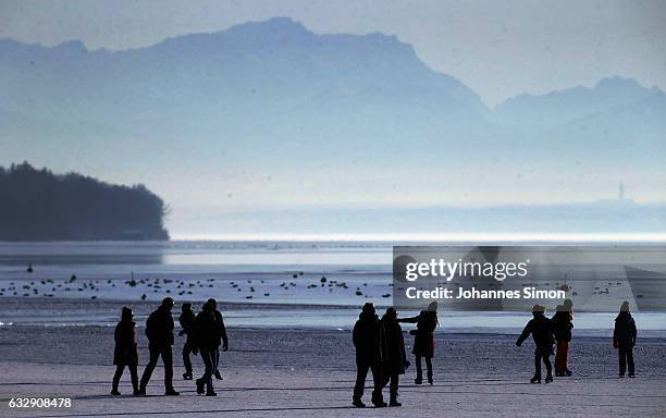 Visitors enjoy skating and walking on Lake Ammersee on January 28, 2017 in Stegen am Ammersee, Germany. After an unusual cold winter period currently...