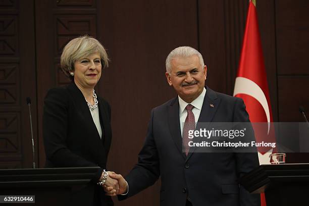 British Prime Minister Theresa May and Turkish Prime Minister Binali Yildirim take part in a press conferencee at his ministerial building on January...