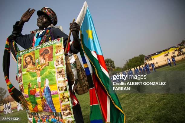 Policeman marches with the South Sudanese flag on January 28 during the opening ceremony of the second National Unity Day at the Juba National...