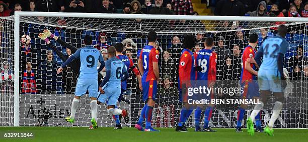 Manchester City's Ivorian midfielder Yaya Toure score their third goal during the English FA Cup fourth round football match between Crystal Palace...