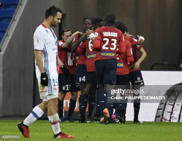 Lille's French forward Nicolas De Preville is congratulated by teamates after scoring a goal during the French L1 football match Olympique Lyonnais...