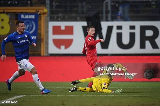 Artjoms Rudnevs of Koeln scores his team's sixth goal past goalkeeper Michael Esser of Darmstadt during the Bundesliga match between SV Darmstadt 98...